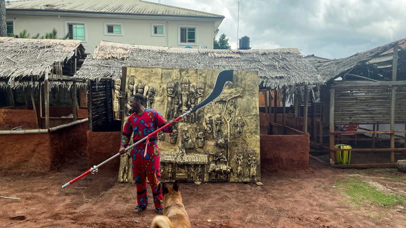 Lucas Osarobo- Okoro, bronze artist is seen in-front of his largest bronze work of Oba Ewuare Ogidigan, ruler of Benin Kingdom 1440-1473 in Benin