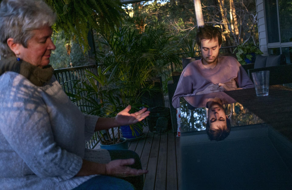 Deb Ware, left, for the first time since seeing her son, Sam, that day begins to cry as she pleads with him to go to rehab at her home in Fountaindale, Central Coast, Australia, Friday, July 19, 2019. "I hope you make the right decision, but I can't make it for you. I can't destroy myself anymore. I just can't. I'm DONE," Deb says, voice breaking. "I've given all I can give to you, Sam. I want to freakin' slap you and kiss you and hug you at the same time. It's so frustrating. It's soul-destroying, and you've nearly freakin' destroyed me." (AP Photo/David Goldman)