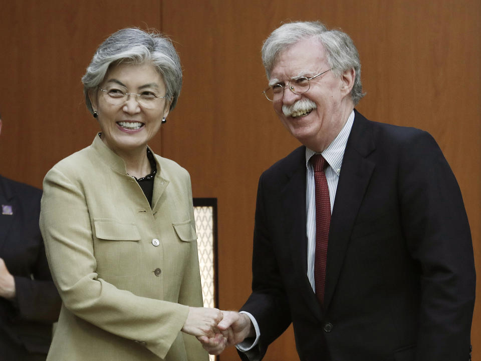 South Korean Foreign Minister Kang Kyung-wha, left, shakes hands with U.S. National Security Advisor John Bolton during a meeting at the foreign ministry in Seoul, South Korea, Wednesday, July 24, 2019. (AP Photo/Ahn Young-joon, Pool)