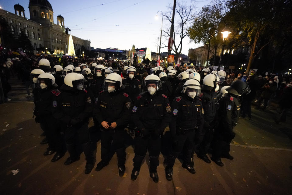 Police officers stand in a circle as they check the identity of demonstrators during a demonstration against measures to battle the coronavirus pandemic in Vienna, Austria, Saturday, Nov. 20, 2021. Thousands of protesters are expected to gather in Vienna after the Austrian government announced a nationwide lockdown to contain the quickly rising coronavirus infections in the country. (AP Photo/Florian Schroetter)