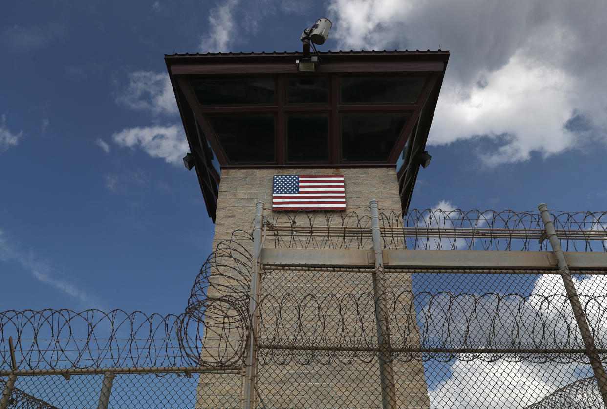 A guard tower stands at the entrance of the Guantanamo Bay prison