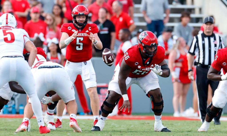 N.C. State’s Lyndon Cooper (56) snaps the ball to quarterback Brennan Armstrong (5) during the second half of the Wolfpack’s 45-7 victory over VMI at Carter-Finley Stadium in Raleigh, N.C., Saturday, Sept. 16, 2023.