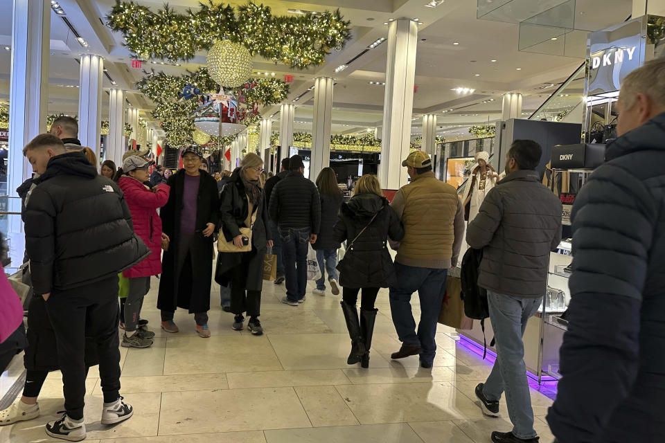 Black Friday shoppers walk through Macy's in Herald Square on Friday, Nov. 24, 2023, in New York. (AP Photo/Anne D'Innocenzio)