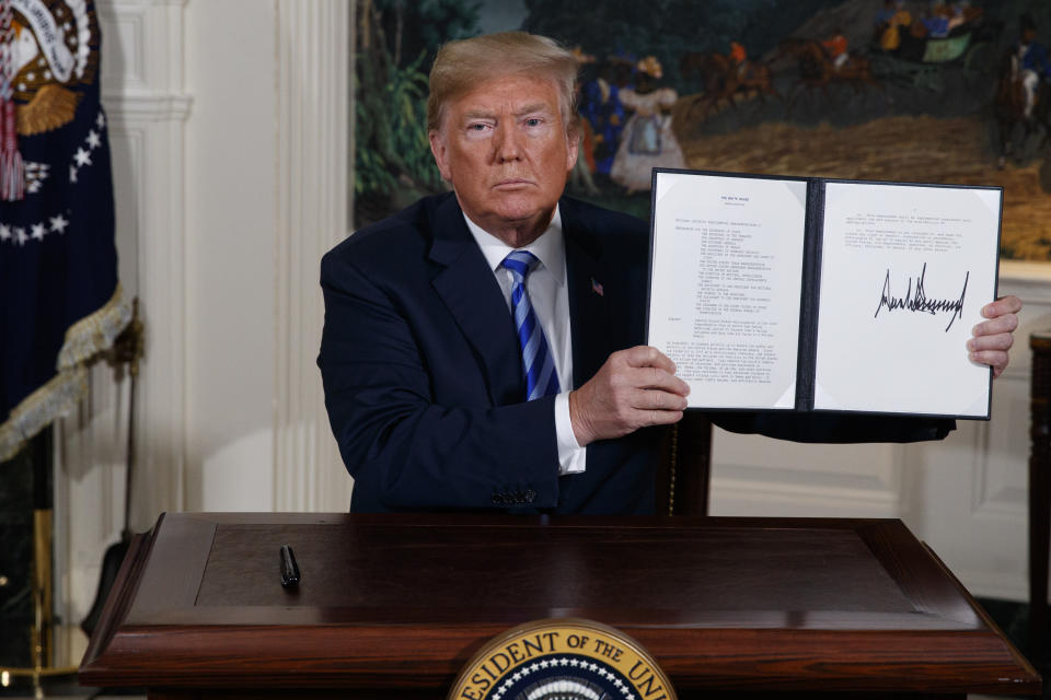 President Trump shows a signed Presidential Memorandum after delivering a statement on the Iran nuclear deal from the Diplomatic Reception Room of the White House on May 8, 2018. (Photo: Evan Vucci/AP)