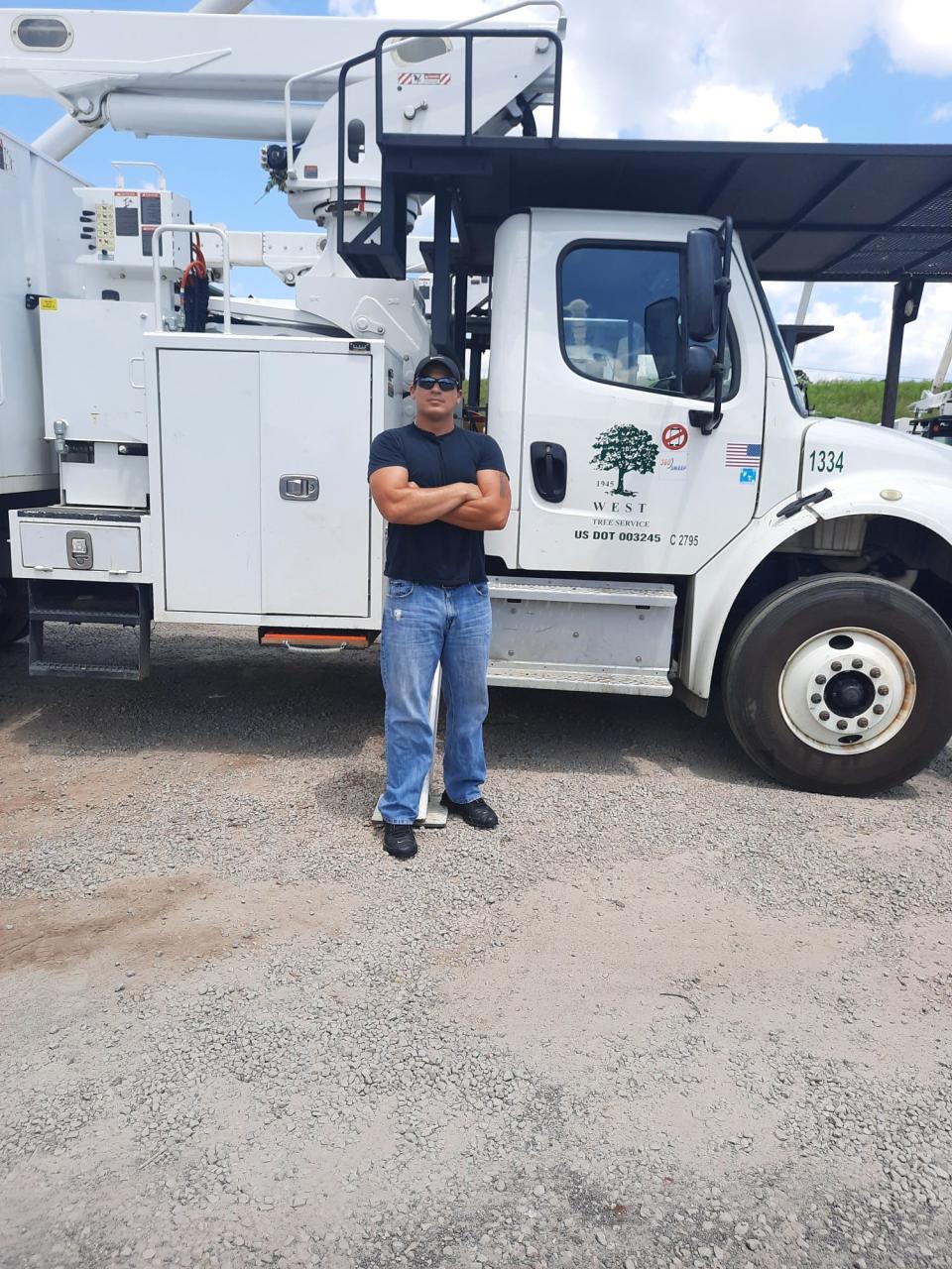 Coty Turner stands in front of a West Tree Service truck in Fort Smith. Turner is a class B trimmer.