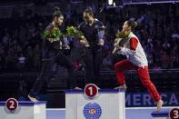 First place all around winner Morgan Hurd of the United States is flanked by second place winner Kayla DiCello of the United States and third place winner Hitomi Hatakeda of Japan after the America Cup gymnastics competition Saturday, March 7, 2020, in Milwaukee. (AP Photo/Morry Gash)