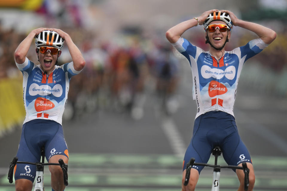 New overall leader France's Romain Bardet, right, crosses the finish line with teammate Netherlands' Frank van den Broek, left, to win the first stage of the Tour de France cycling race over 206 kilometers (128 miles) with start in Florence and finish in Rimini, Italy, Saturday, June 29, 2024. (AP Photo/Daniel Cole)