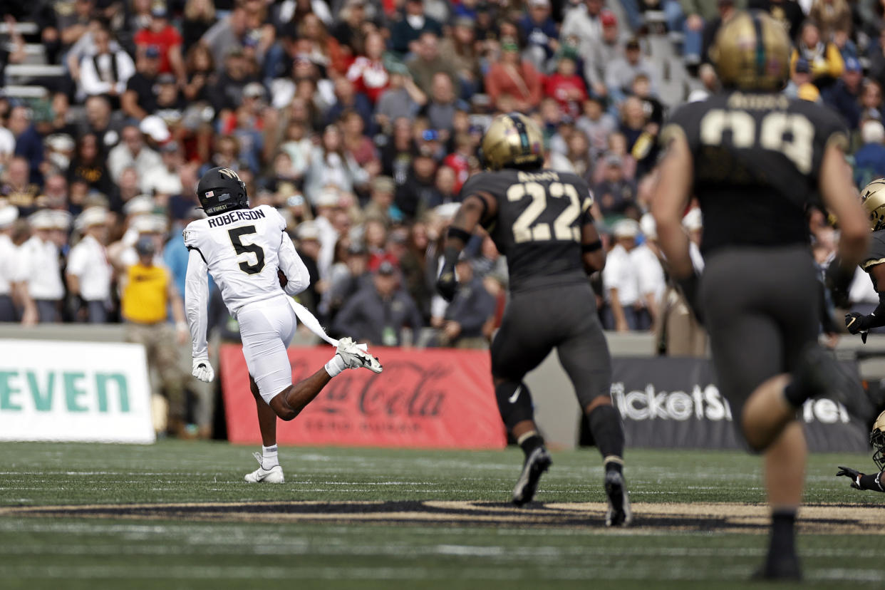 Wake Forest wide receiver Jaquarii Roberson (5) runs for a touchdown past Army linebacker Malik Birchett (22) during the second half of an NCAA college football game Saturday, Oct. 23, 2021, in West Point, N.Y. Wake Forest won 70-56. (AP Photo/Adam Hunger)
