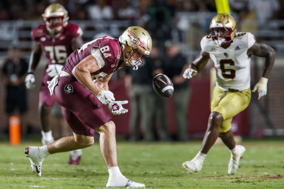 Florida State tight end Kyle Morlock (84) can't hold up a pass as Boston College defensive end Donovan Ezeiruaku (6) surrounds him during the second half of an NCAA college football game, Monday, Sept. 2, 2024, in Tallahassee, Fla. (AP Photo/Colin Hackley)