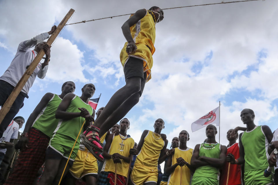 A Maasai man competes in the high-jump competition at the Maasai Olympics in Kimana Sanctuary, southern Kenya Saturday, Dec. 10, 2022. The sports event, first held in 2012, consists of six track-and-field events based on traditional warrior skills and was created as an alternative to lion-killing as a rite of passage. (AP Photo/Brian Inganga)