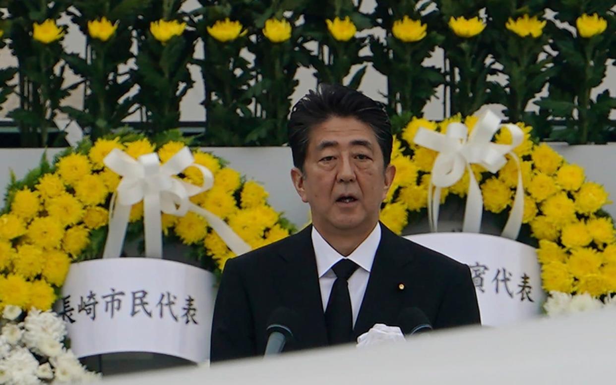 Japanese prime minister Shinzo Abe delivers a speech during a ceremony to mark the 75th anniversary of the bombing at the Hiroshima Peace Memorial Park on Thursday - AP Photo/Eugene Hoshiko