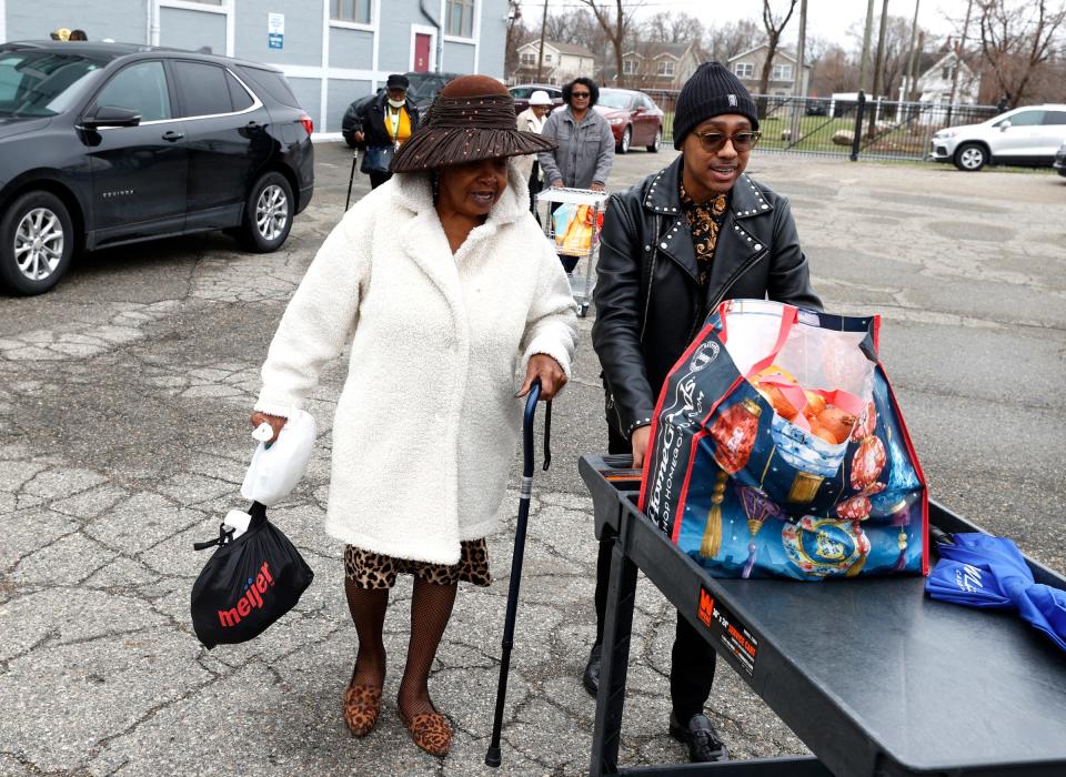 D.D. Flowers, 67, of Detroit, left, talks with Deon Mullen, 40, the senior director of senior outreach services at Franklin Wright Settlements in Detroit, as he helps to take her Easter dinner to her SUV on Tuesday, April 4, 2023. Over 20 seniors were there for the twice-weekly "Food and Friendship," where they play games, do exercise routines and have lunch. Usually during Easter time, the seniors have food for an Easter celebration delivered to their homes but that couldn't happen this year so Mullen made sure that the seniors had Easter dinner they could take home with them to make.
