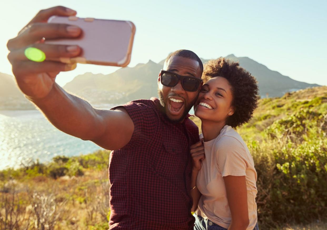 Two people, one profile pic. <a href="https://www.shutterstock.com/image-photo/young-couple-pose-holiday-selfie-on-670636513" rel="nofollow noopener" target="_blank" data-ylk="slk:Monkey Business Images/Shutterstock.com;elm:context_link;itc:0;sec:content-canvas" class="link ">Monkey Business Images/Shutterstock.com</a>