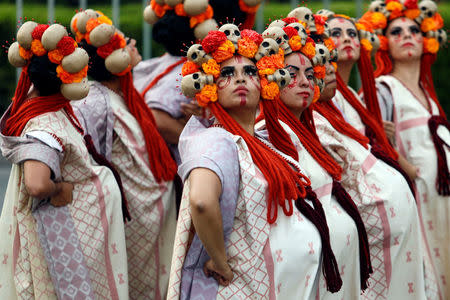 Women dressed up as "Catrinas", a Mexican character also known as "The Elegant Death", participate in a procession to commemorate Day of the Dead in Mexico City, Mexico, October 28, 2017. REUTERS/Edgard Garrido