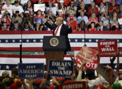 President Donald Trump reacts as supporters wave signs during a rally Wednesday, Oct. 31, 2018, in Estero, Fla. (AP Photo/Chris O'Meara)