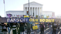 People demonstrate in front of the U.S. Supreme Court Wednesday, Dec. 1, 2021, in Washington, as the court hears arguments in a case from Mississippi, where a 2018 law would ban abortions after 15 weeks of pregnancy, well before viability. (AP Photo/Jacquelyn Martin)