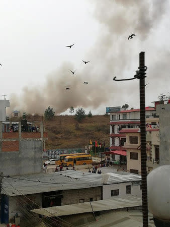 Smoke rises following the crash of a Bangladeshi aircraft at Kathmandu airport, Nepal March 12, 2018 in this picture obtained from social media. RUSHA GIRI/via REUTERS