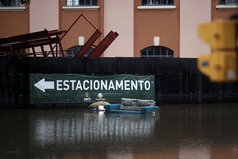 TOPSHOT - A sofa float in a flooded atreet at the historical city center of Porto Alegre, Rio Grande do Sul, Brazil on May 12, 2024. New rains in waterlogged southern Brazil are expected to be heaviest between Sunday and Monday, authorities have warned, bringing fresh misery to victims of flooding that has killed 136 people and left 806 injured and 125 missing so far. (Photo by Anselmo CUNHA / AFP)