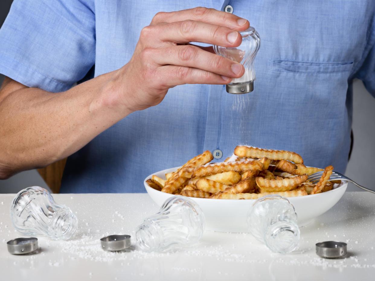 UK guidelines recommend not adding salt to food as it increases blood pressure and is already abundant in staples like bread: Getty Images / ClarkandCompany