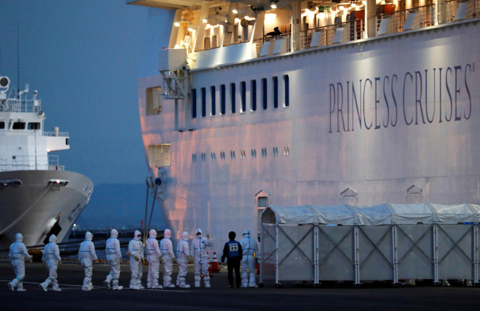 Officers in protective gear enter the cruise ship Diamond Princess, where 10 more people were tested positive for coronavirus on Thursday, to transfer a patient to the hospital after the ship arrived at Daikoku Pier Cruise Terminal in Yokohama, south of Tokyo, Japan February 7, 2020. REUTERS/Kim Kyung-Hoon REFILE - ADDING INFORMATION