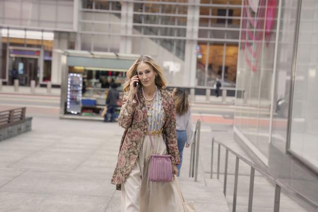 Premium Photo  Trendy beautiful young woman in fashionable casual wear  outfit with a leather jacket with bellbottom highwaisted jeans and white  sneakers walks near a red brick store building