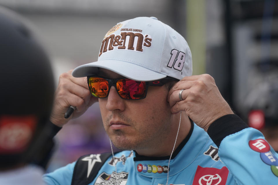 Kyle Busch adjusts his earpieces as he stands on pit road during qualifying for the NASCAR All-Star auto race at Texas Motor Speedway in Fort Worth, Texas, Saturday, May 21, 2022. (AP Photo/LM Otero)