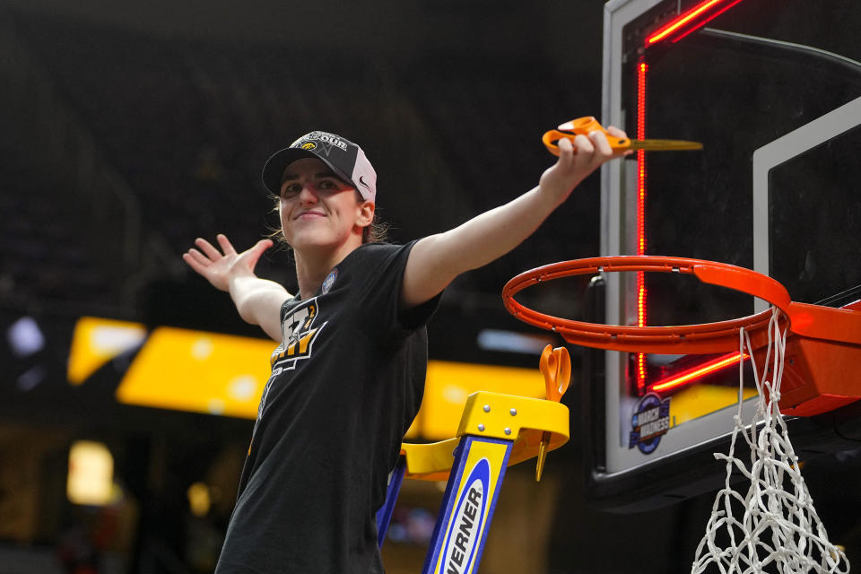 Iowa Hawkeyes guard Caitlin Clark cuts the net after defeating LSU on Monday. (Gregory Fisher-USA TODAY Sports)