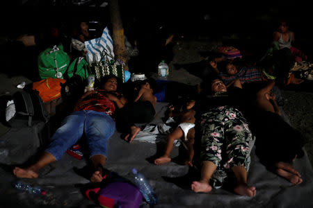 Members of a caravan of thousands of migrants from Central America en route to the U.S, rest after a clash with the Mexican Police near the border gate, with the intention to carry on their journey, in Tecun Uman, Guatemala, October 28, 2018. REUTERS/Carlos Garcia Rawlins