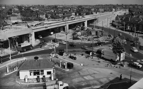 An elevated view looking onto the construction of the Chiswick Flyover and the through road over a 400ft diameter roundabout with a 40ft wide carriageway at the junction of the North Circular Road, Chiswick High Road, the road to Kew Bridge and the Great West Road circa June 1959 in London, United Kingdom. In the centre of the picture is the Esso petrol station and a Police telephone box. (Photo byFox Photos/Hulton Archive/Getty Images). - Credit: Fox Photos/Hulton Archive/Getty Images