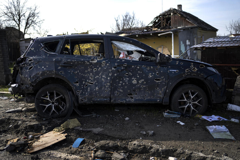 A car riddled with bullet holes due to the war with Russia is seen in Bucha, in the outskirts of Kyiv, Ukraine, Monday, April 11, 2022. (AP Photo/Rodrigo Abd)