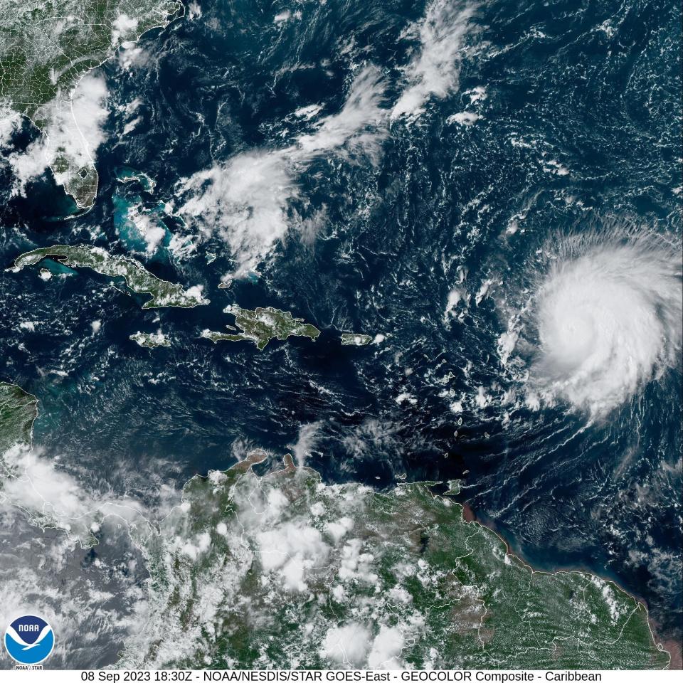 A satellite image shows Hurricane Lee (right) spinning in the western Atlantic Ocean on Friday afternoon, Sept. 8, 2023. Florida can be seen at the upper left.