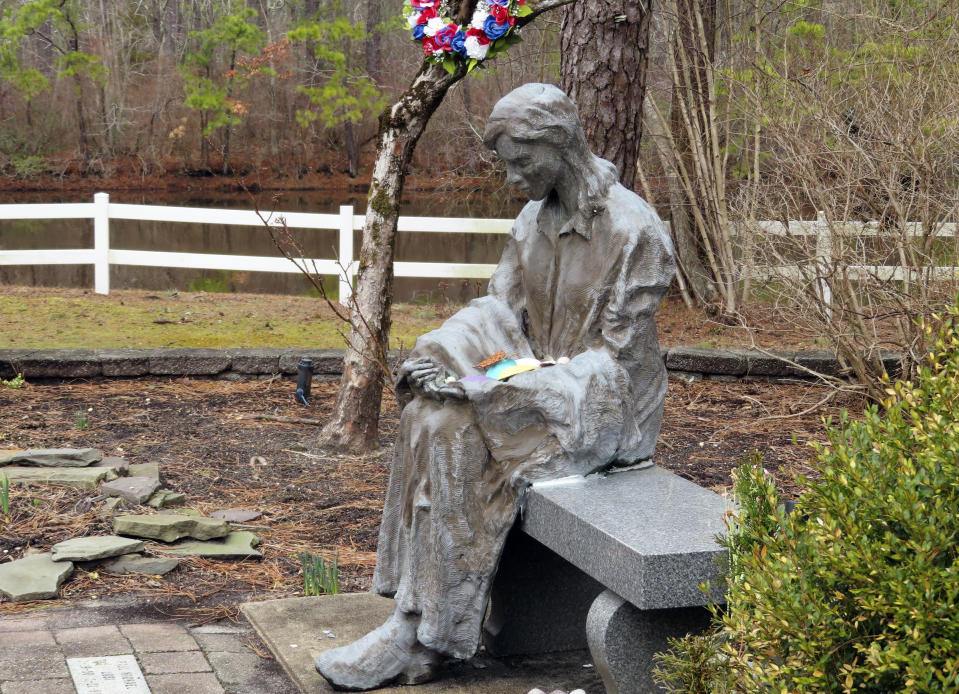 A sculpture of a grieving mother sits at a memorial garden, Feb. 21, 2023, in Toms River, N.J. for children who died from any cause. Many residents of Toms River, where the former Ciba-Geigy chemical plant dumped toxic waste into the Toms River and directly onto the ground, oppose a settlement with the site's current owner, BASF Corp. to restore natural resources at the site as inadequate and ill-advised. (AP Photo/Wayne Parry)
