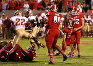 Niklas Sade #32 of the North Carolina State Wolfpack celebrates with teammates after kicking an extra point that won the game 17-16 against the Florida State Seminoles during their game at Carter-Finley Stadium on October 6, 2012 in Raleigh, North Carolina. (Photo by Streeter Lecka/Getty Images)