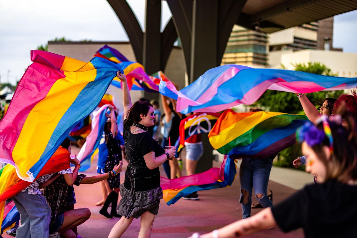 Dozens line the stage waving flags during the 2022 Pride Event held at Unity Square in September.