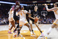 South Carolina guard Brea Beal (12) drives as she is defended by Tennessee guard Jordan Walker (4) during the second half of an NCAA college basketball game, Thursday, Feb. 23, 2023, in Knoxville, Tenn. (AP Photo/Wade Payne)