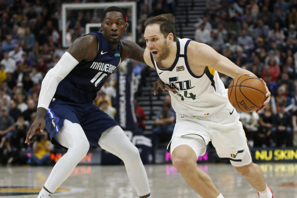 Dallas Mavericks forward Dorian Finney-Smith (10) guards Utah Jazz forward Bojan Bogdanovic (44) in the second half during an NBA basketball game Saturday, Jan. 25, 2020, in Salt lake City. (AP Photo/Rick Bowmer)