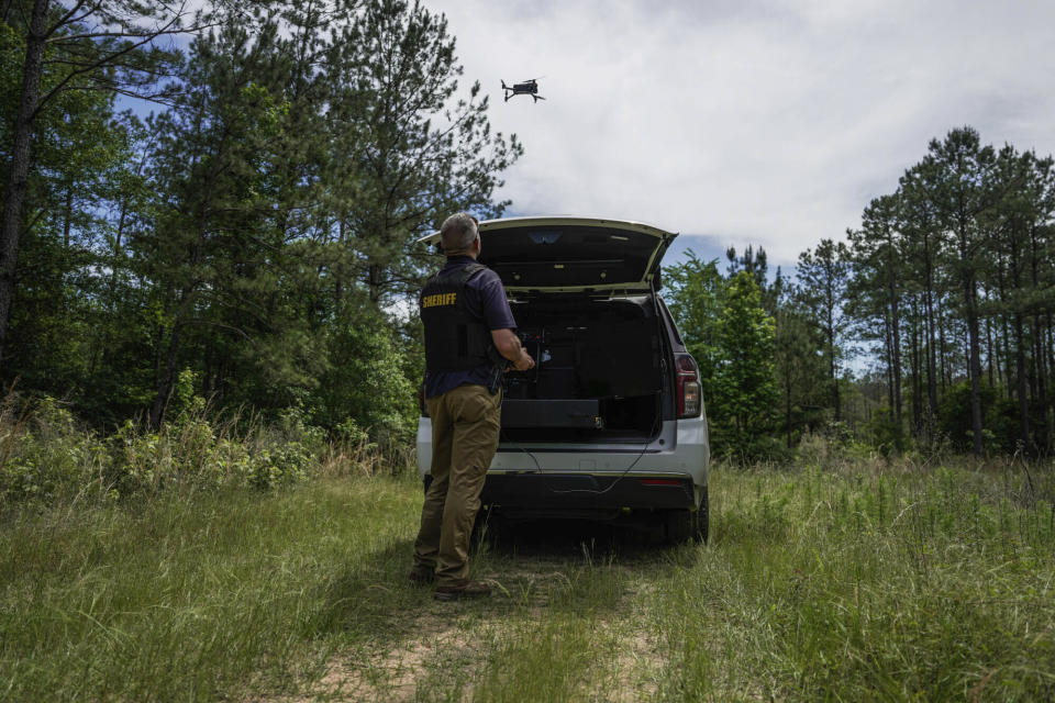 Authorities search wooded areas with drones, in Cleveland, Texas, Monday, May 1, 2023, for a suspect who fatally shot five neighbors several days earlier. (Raquel Natalicchio/Houston Chronicle via AP)