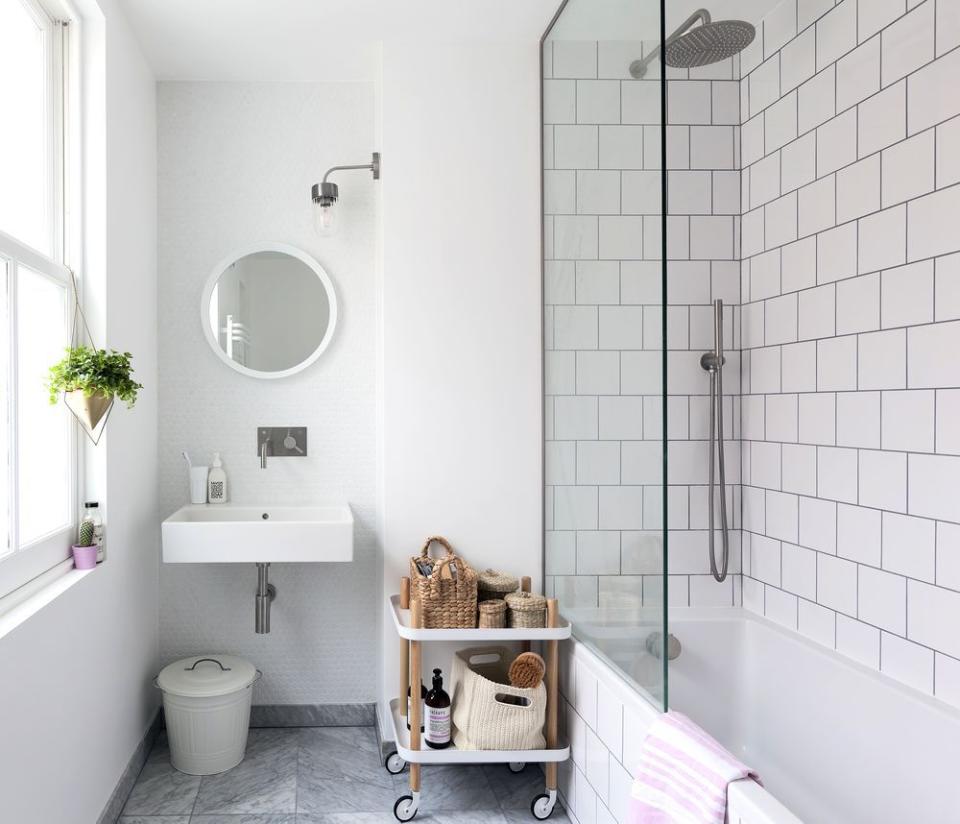 <p>This simple all-white bathroom has been pepped up with hanging plants, wooden features and contemporary tiles. </p><p><a class="link " href="https://www.housebeautiful.com/uk/renovate/homes-makeovers/a1650/light-bright-period-house-west-sussex/" rel="nofollow noopener" target="_blank" data-ylk="slk:TAKE A TOUR;elm:context_link;itc:0;sec:content-canvas">TAKE A TOUR</a></p>