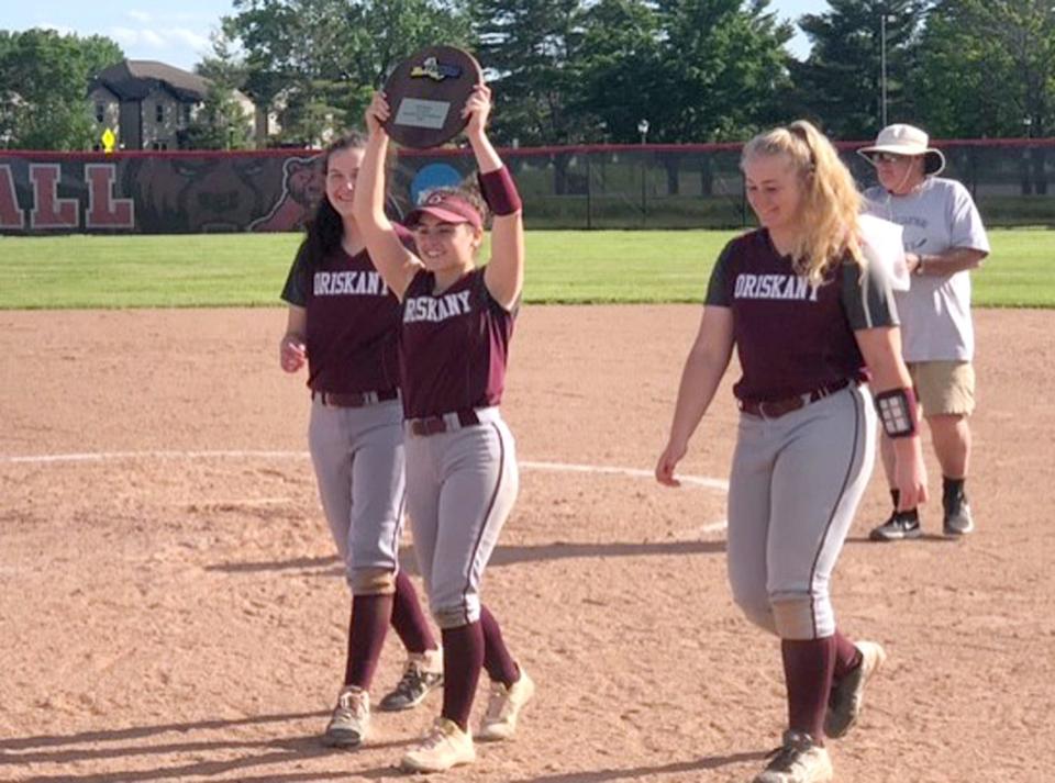 The Oriskany Redskins hoist their plaque as Class D regional champions after Saturday's win in Potsdam.