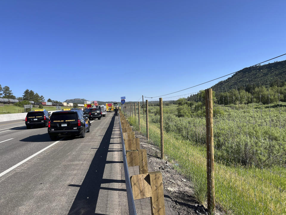 In this photo provided by Douglas County Sheriff's Office posted on X, multiple agencies respond to a small plane crash in a field just east of I-25, around the Larkspur, Colo., exit, Sunday, June 16, 2024. The Douglas County Sheriff's Office says the plane apparently hit a sign on the highway, causing it to veer off to the east before crashing. Officials say two people were seriously injured in the crash. (Douglas County Sheriff's Office via AP)