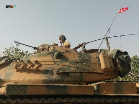 A Turkish army soldier on a tank makes his way towards the Syrian border town of Jarablus, Syria August 24, 2016. Picture taken August 24, 2016. Revolutionary Forces of Syria Media Office/Handout via REUTERS