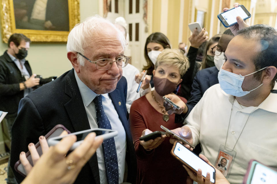 In this Oct. 19, 2021 photo, Sen. Bernie Sanders, I-Vt., pauses while speaking to reporters as he leaves a Democratic strategy meeting at the Capitol in Washington. Divided Democrats struggling to enact President Joe Biden’s domestic agenda are confronting one of Congress’ cruelest conundrums — your goals may be popular, but that doesn't ensure they'll become law or that voters will reward you. (AP Photo/Andrew Harnik)