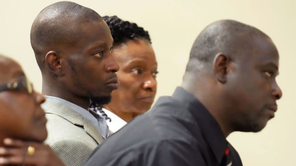 Michael Corey Jenkins, center, and Eddie Terrell Parker, right, listen as one of six former Mississippi law officers pleads guilty to state charges at the Rankin County Circuit Court in Brandon, Mississippi. - Rogelio V. Solis/AP