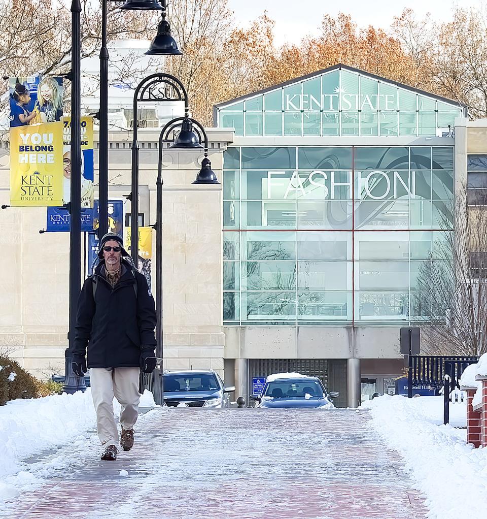 Kent State University Math Instructor Randy Ruchotzke makes his way back to his car after class on a chilly, snowy afternoon.