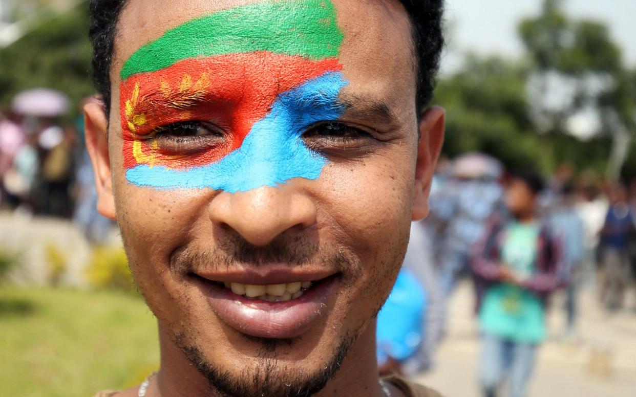 A man in Addis Ababa with the Eritrean national flag painted on his face in July 2018 - REUTERS
