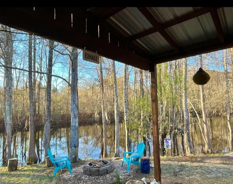 This tiny home cabin in Conway sits next to a pond and offers a camper’s retreat.