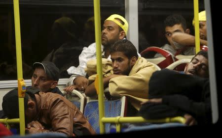 Migrants sit in a bus bound for Austria and Germany, along the M1 highway near Budapest, Hungary, September 5, 2015. REUTERS/David W Cerny