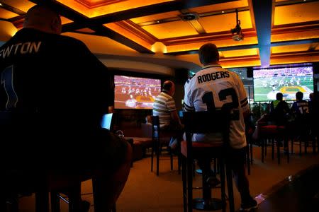 Australian NFL fans watch the telecast of the NFL Super Bowl on a large screen at the Western Suburbs Leagues Club in Leumeah, located west of Sydney, Australia, February 8, 2016. REUTERS/David Gray