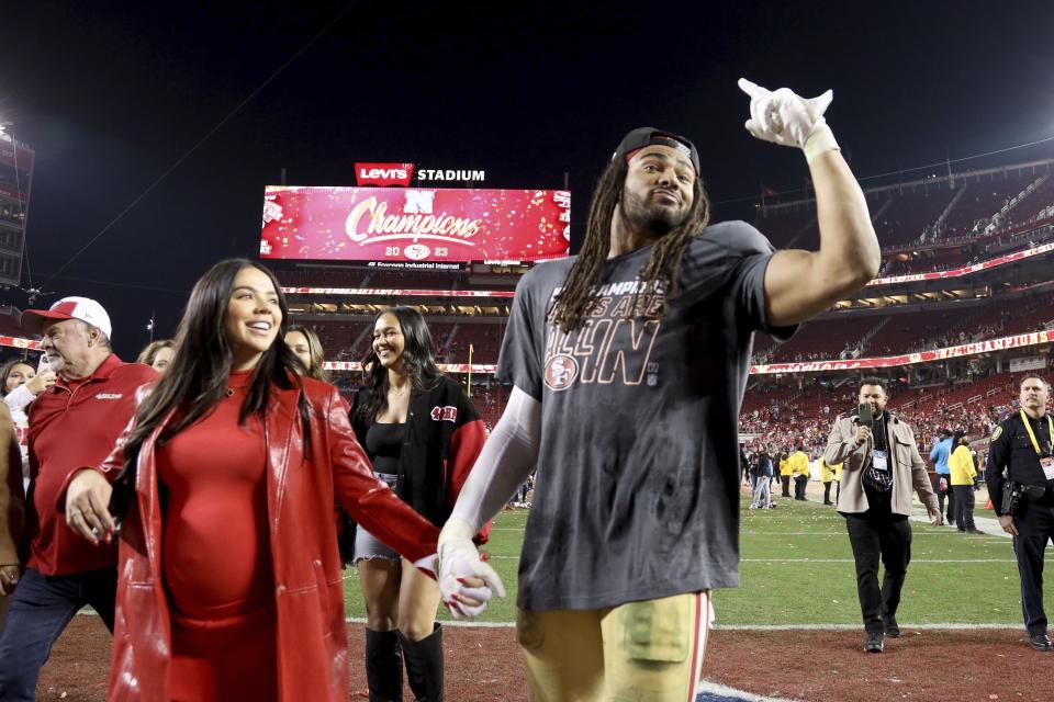 San Francisco 49ers linebacker Fred Warner (54) and wife Sydney Hightower walk on the field after the NFC Championship NFL football game against the Detroit Lions in Santa Clara, Calif., Sunday, Jan. 28, 2024. | Scot Tucker, Associated Press