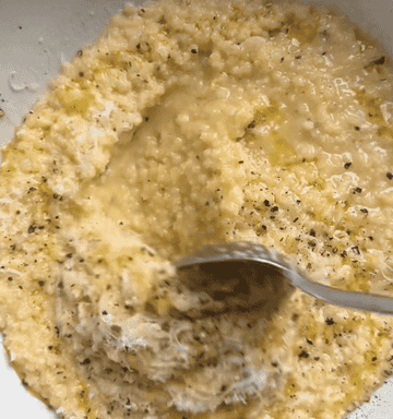 gif of creamy pastina dish with cheese and pepper getting mixed around in a bowl